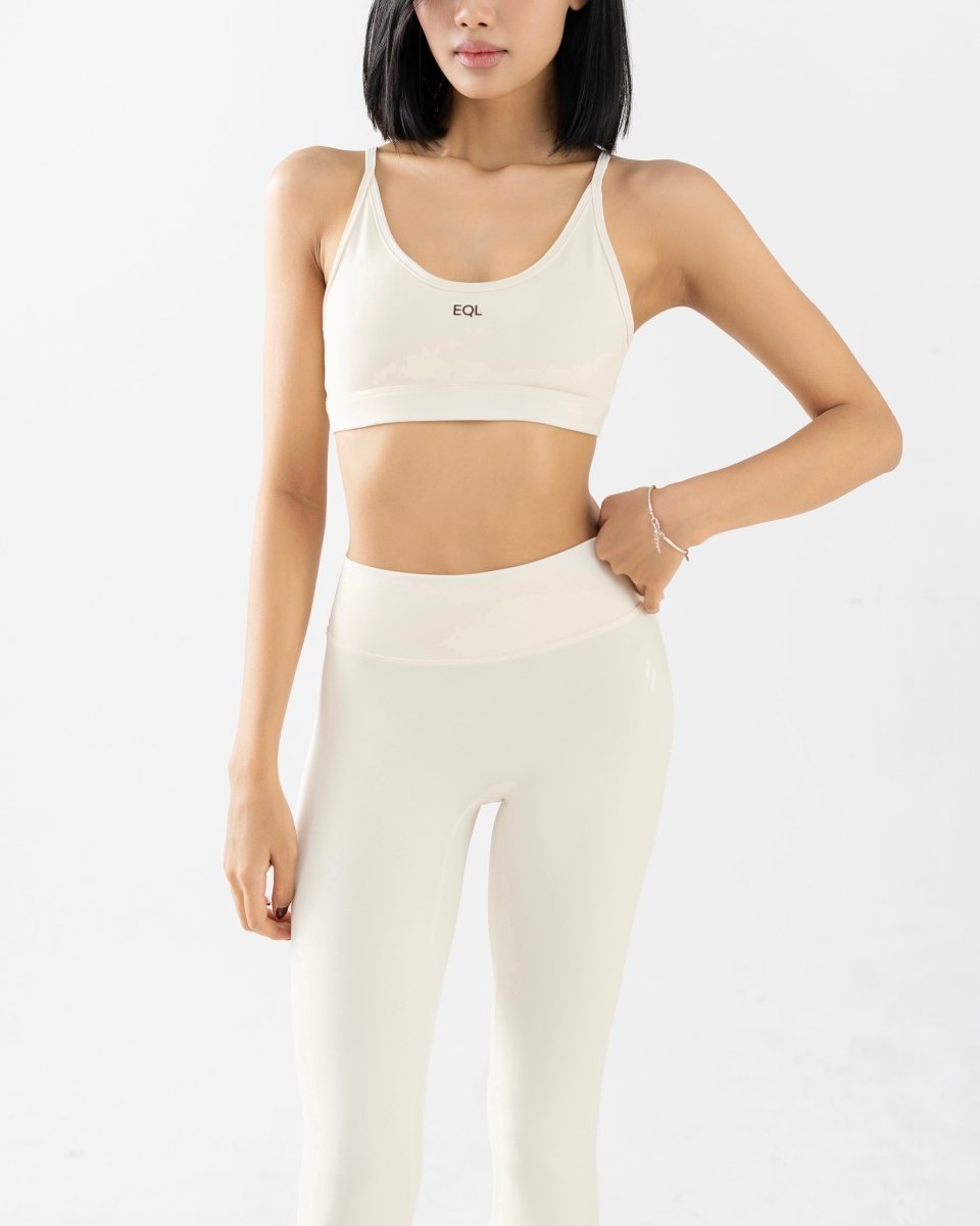 front side close up of women's sports bra and high waisted legging in white