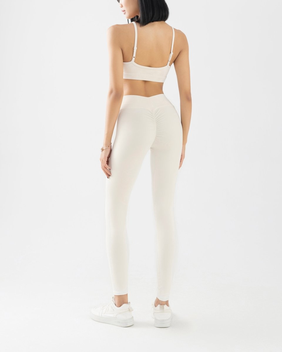 back side of women's sports bra and high waisted legging in white
