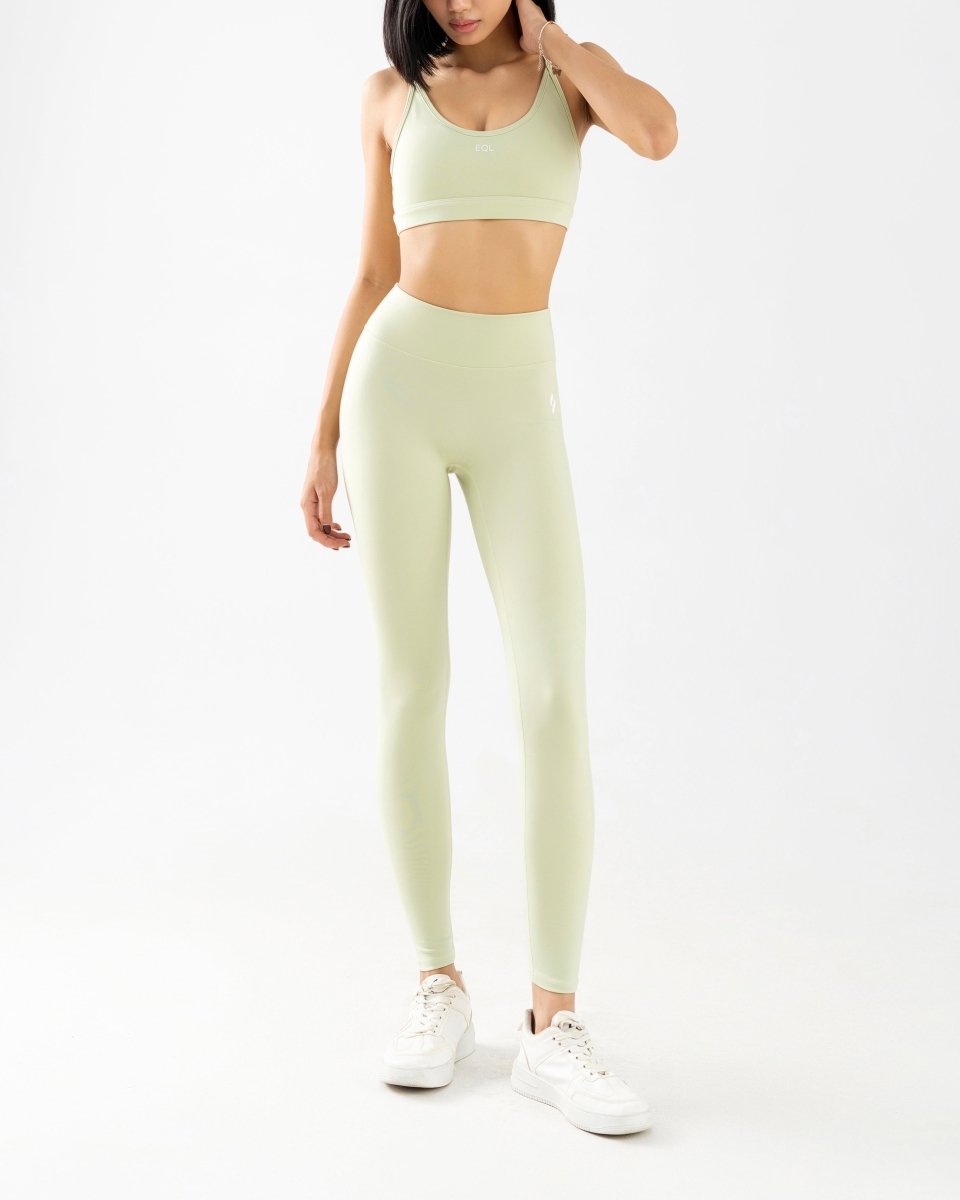 front side of women's sports bra and high waisted legging in green
