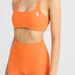 close up front side of women's sports bra in orange