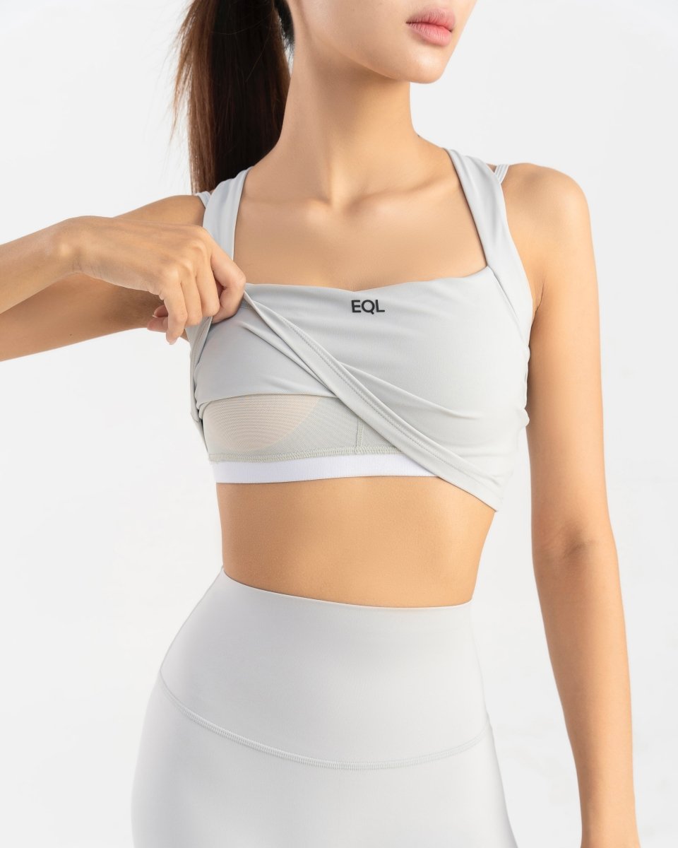 close up front side of women's sports bra showing inner bra padding in grey