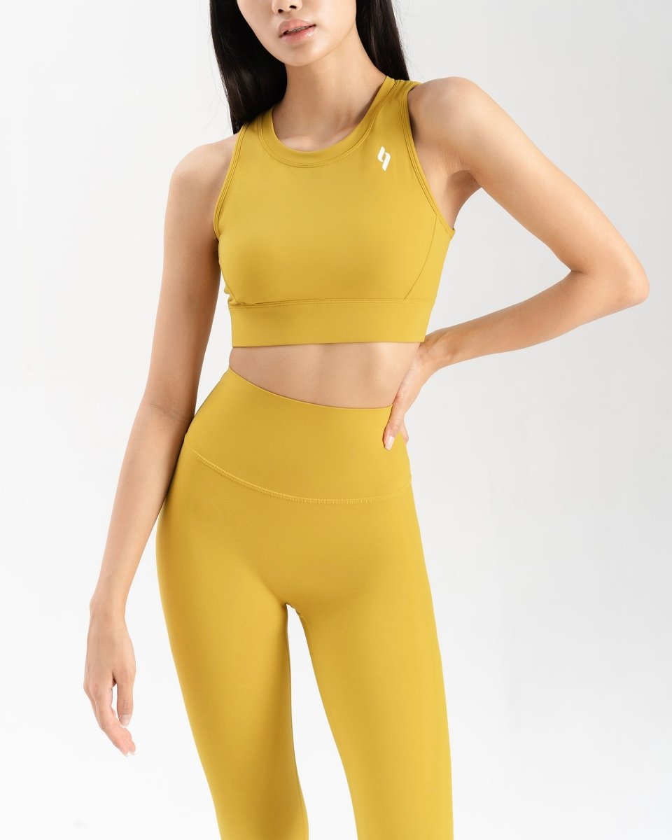 close up front side of women's activewear set in mustard yellow